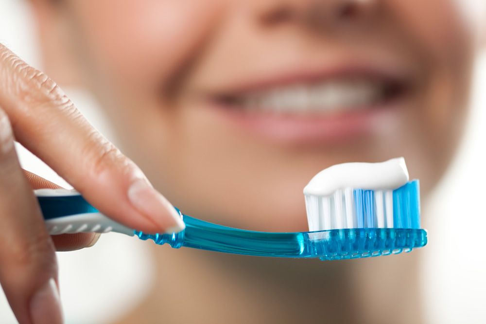 A person holding a toothbrush